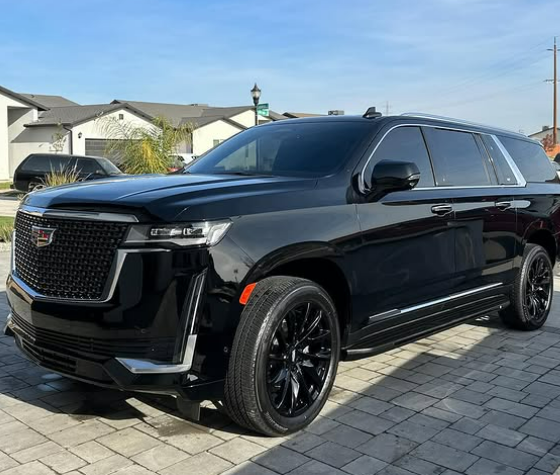 Black Cadillac Escalade with glossy reflection on the paint