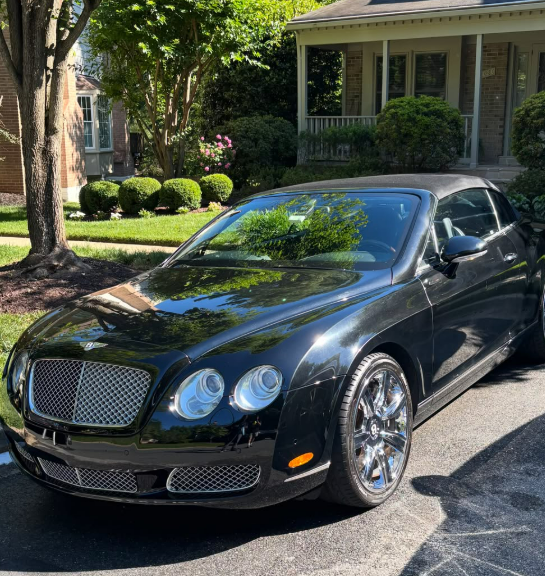 Black Bentley convertible with deep glossy reflection